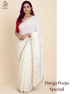 White saree with golden threadwork and red blouse – Durga Pooja special festive wear.